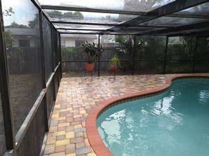 Pool deck and cage cleaning after Palm Harbor